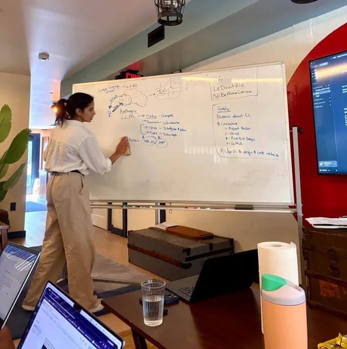 Nadeen sketching a system diagram on the whiteboard at the August 2026 Claude Code Workshop