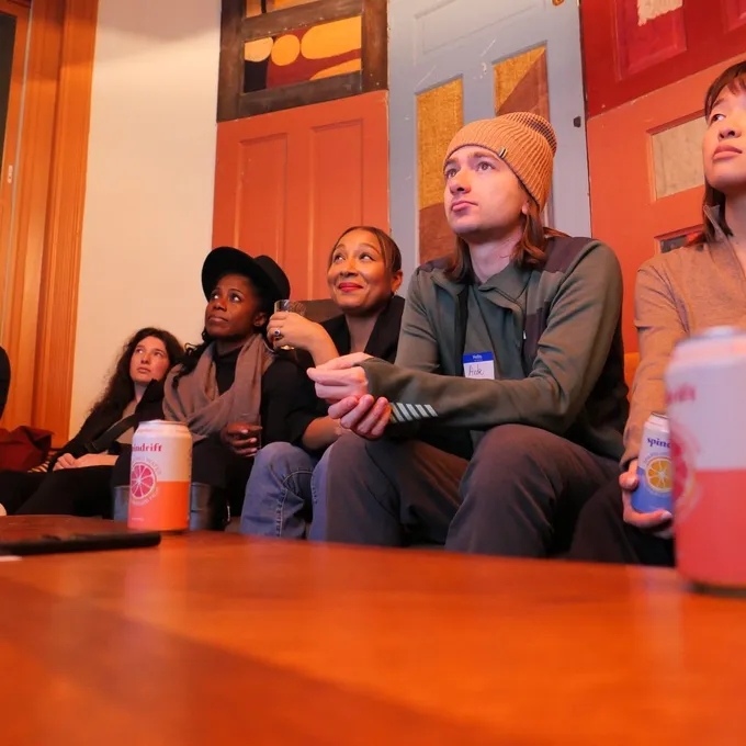 Attendees on couches in conversation at the February 2026 event